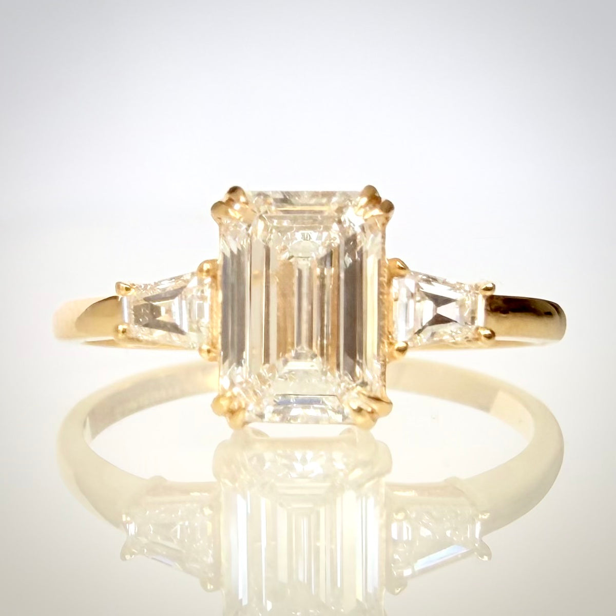 1,20 ct Emerald Cut trilogy-timanttisormus suoraan edestä